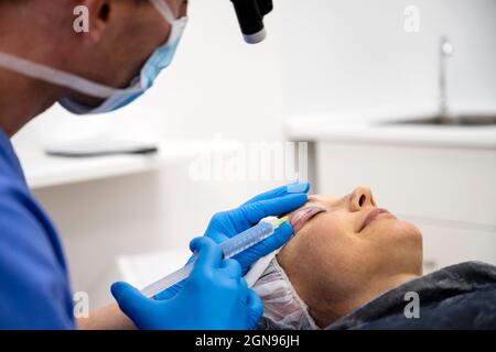 Surgeon process of blepharoplasty surgery.Apply anesthesia in eyelid Stock Photo