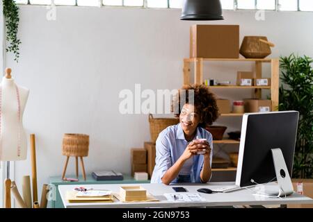 Businesswoman using desktop while working at studio Stock Photo