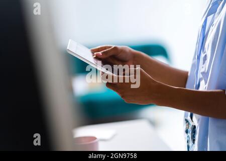 Female entrepreneur holding digital tablet at studio Stock Photo