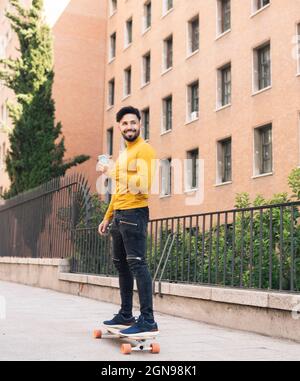 Smiling handsome bearded man leaning on railing Stock Photo