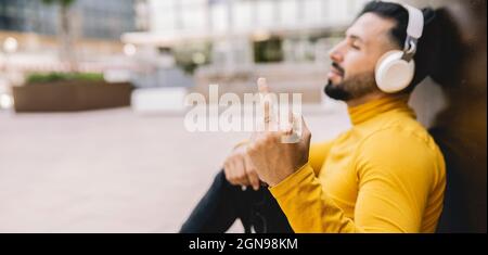 Thoughtful male student with papers in city Stock Photo
