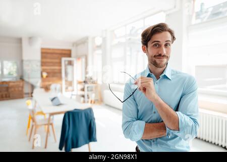 Male business professional with eyeglasses in office Stock Photo