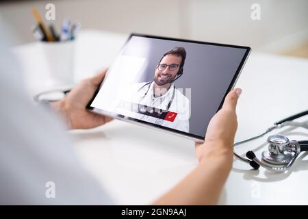 Doctor In Online Medical Video Conference With Colleague Hospital Worker Stock Photo