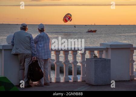 Sochi, Russia. 17th of September, 2021 An elderly couple looks at the sunset over the Black Sea from the central embankment in Sochi city, Russia Stock Photo