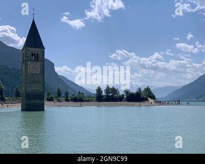The submerged city and the only bell tower left emerging from the lake in Italy Stock Photo