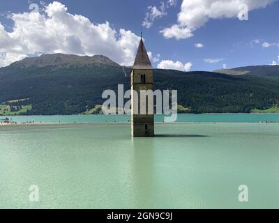The bell tower of Curon in the italian Alps, remaining part of a submerged city Stock Photo