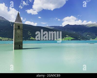 The submerged city and the only bell tower left emerging from the lake in Italy Stock Photo