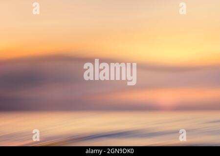 Abstract sunset landscape background in light soft pink, purple, yellow and blue colors. Fine art, copy space, motion blur Stock Photo