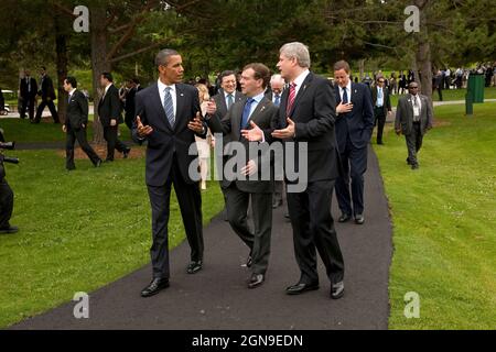 President Barack Obama talks with Russian President Dmitry Medvedev and Canadian Prime Minister Stephen Harper as as they walk with other leaders, following the family photo, at the G8 Summit in Muskoka, Canada, June 25, 2010.  (Official White House Photo by Pete Souza) This official White House photograph is being made available only for publication by news organizations and/or for personal use printing by the subject(s) of the photograph. The photograph may not be manipulated in any way and may not be used in commercial or political materials, advertisements, emails, products, promotions tha Stock Photo