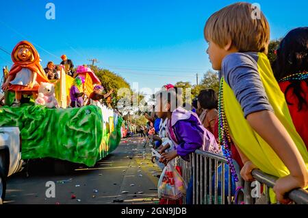 Children watch a Mardi Gras float with a Little Red Riding Hood theme during the Joe Cain Day Mardi Gras parade in Mobile, Alabama. Stock Photo