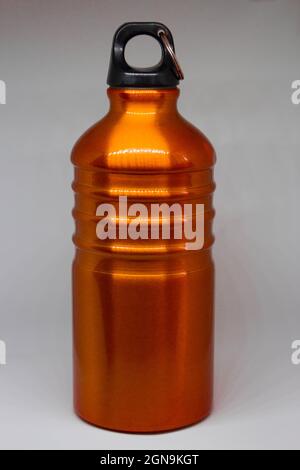 Orange and yellow flask on a white background. Thermos for campers. Cute color. Stock Photo