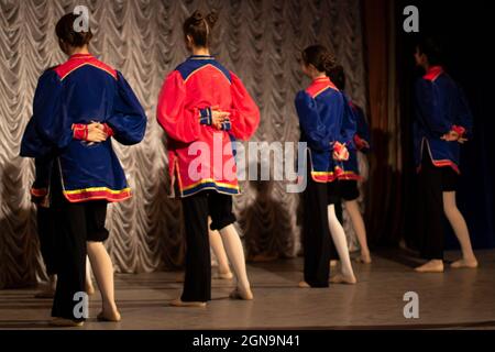 Dance lesson on stage. The girls are performing. Choreographic in teenagers. Creative activity. Group class on synchronized movement. Stock Photo