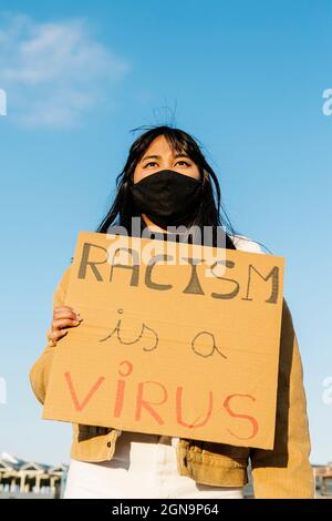 Vietnamese young student in face mask protesting during stop asian hate campaign Stock Photo