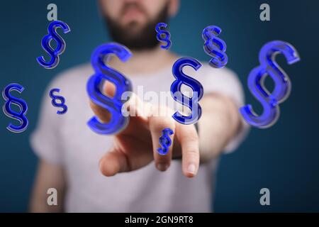 Man on the background clicking on a 3d illustration of blue paragraph symbols Stock Photo