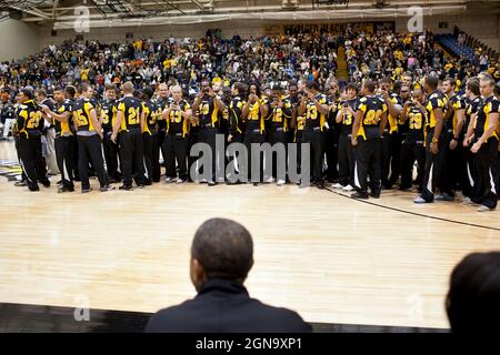 Members of the Townson University football team take pictures of President Barack Obama during halftime of the Oregon State vs Towson University basketball game in Towson, Md., Nov. 26, 2011. Members of the football team were honored for winning the Colonial Athletic Association regular-season title. (Official White House Photo by Pete Souza) Stock Photo