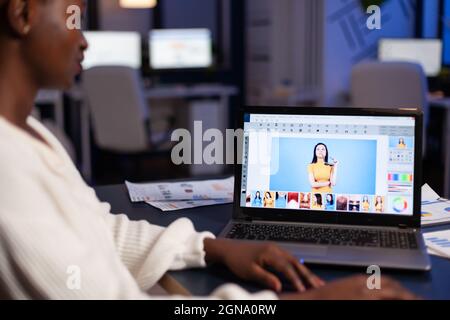Exhausted african photographer editor retouching artist deadline project editing photography working late at night in company office. Creative retoucher using creativity design software technology Stock Photo