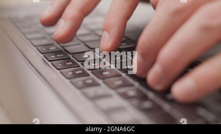 Close up macro of hands typing on laptop keyboard mac computer Stock Photo