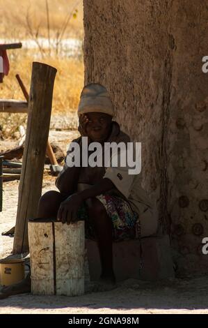 Old African woman in front of his house at Khwai Village between Moremi Reserve and Chobe Park, Botswana Stock Photo