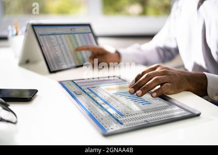 Electronic Spreadsheet Analyst Or Auditor Using Software On Hybrid Laptop Stock Photo