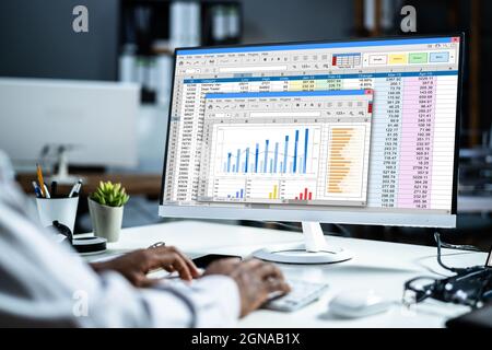 Spreadsheet Data Analyst Working Late On PC Computer Stock Photo