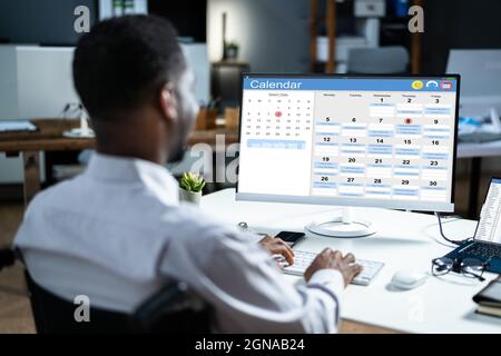African American Doing Calendar Schedule Planning. Business Agenda In Office Stock Photo
