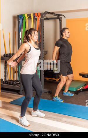 People stretching arms back in the gym Stock Photo