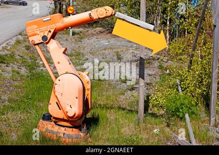 Umea, Norrland Sweden - May 15, 2021: abandoned industrial robot that gets to work as a sign pointer Stock Photo