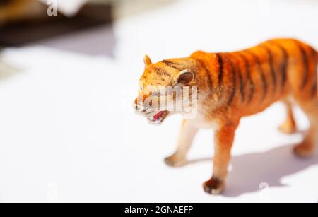 plastic toy tiger on white table Stock Photo
