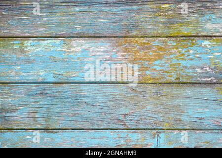 Horizontal wooden planks background with teal blue and yellow colored old weathered planks with chipped paint Stock Photo