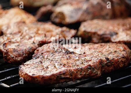 BBQ meat on flame gas grill Stock Photo - Alamy