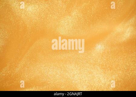 Golden glitter abstract background. Glamorous golden glittering magical bright festive background for New Year's party decor. High quality photo Stock Photo