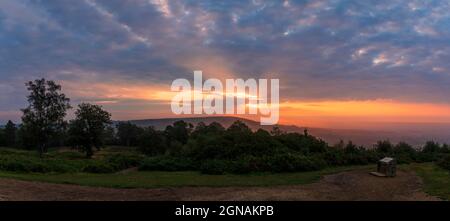 Dramatic September sunrise behind Leith hill from Holmbury Hill on the Surrey Hills, south east England Stock Photo