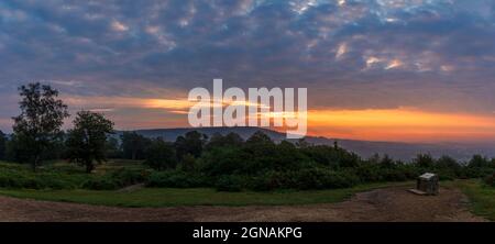 Dramatic September sunrise behind Leith hill from Holmbury Hill on the Surrey Hills, south east England Stock Photo