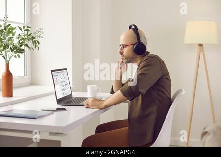 Man using digital calendar on laptop computer, thinking and planning work schedule Stock Photo