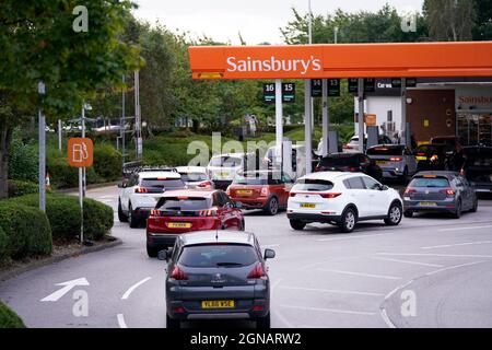 Queues at a Sainsbury's Petrol Station in Colton, Leeds. Drivers are being urged by the Government to 'buy fuel as normal', after the lorry driver shortage hit supplies. BP said a 'handful' of its filling stations are closed due to a lack of fuel available, while Esso owner ExxonMobil also said a 'small number' of its Tesco Alliance petrol forecourts have been impacted. Picture date: Friday September 24, 2021. Stock Photo