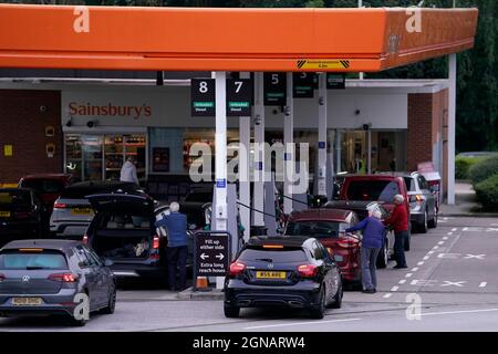 Queues at a Sainsbury's Petrol Station in Colton, Leeds. Drivers are being urged by the Government to 'buy fuel as normal', after the lorry driver shortage hit supplies. BP said a 'handful' of its filling stations are closed due to a lack of fuel available, while Esso owner ExxonMobil also said a 'small number' of its Tesco Alliance petrol forecourts have been impacted. Picture date: Friday September 24, 2021. Stock Photo