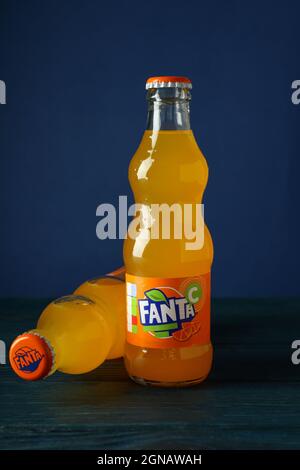 Odessa, Ukraine - September 23, 2021: Fanta bottles on wooden table against blue background Stock Photo