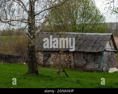 old stone barn in the village, in spring Stock Photo
