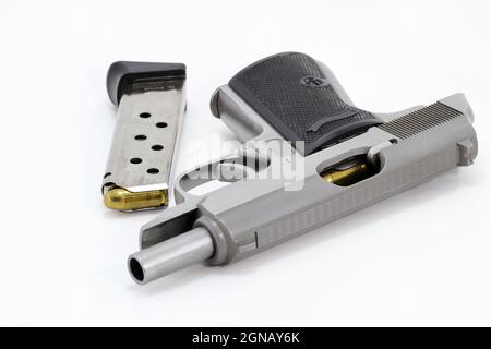 The compact Semi automatic pistol, stainless steel PPKs pistol open slide with spare magazine right side view, Ready for use, lying isolated on white Stock Photo