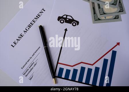 Lease agreement,  rising car prices concept. Lease agreement money and pen. Stock Photo