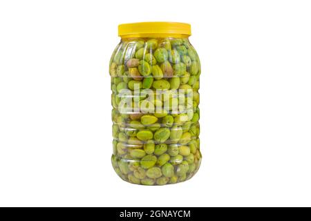 Pickled green olives. Brine green crushed olives in the bottle isolated on white background. Stock Photo