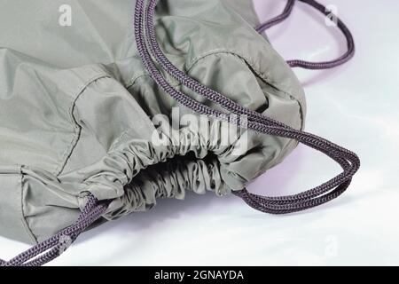 Close up green drawstring bag or backpack with laces,  Sport bag isolated on white background. Stock Photo