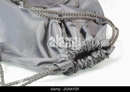 Close up gray drawstring bag or backpack with laces,  Sport bag isolated on white background. Stock Photo