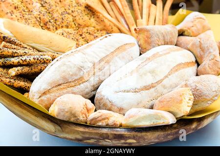 Fresh homemade bread composition in basket. Various types of wheat bakery in Sunday market. Nutrition exhibition. Italian traditional bakery. focaccia Stock Photo