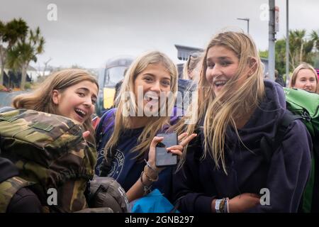 A group of excited young girls arriving at Newquay Train Station for the Boardmasters Festival in Cornwall. Stock Photo