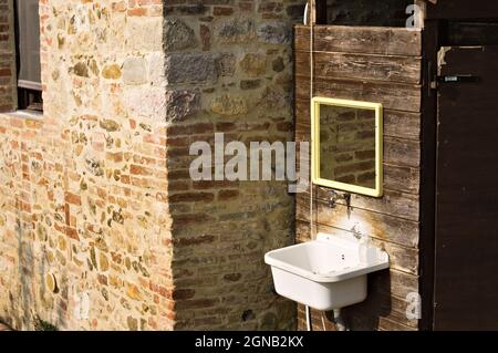 An external sink under a mirror in the garden of a farmhouse in the countryside (Umbria, Italy, Europe) Stock Photo