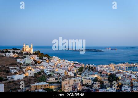 Panoramic view of Ermoupolis, the capital of Cyclades, Greece, with the church of St Nicholas on the left and the Aegean Sea in the background. Photo Stock Photo