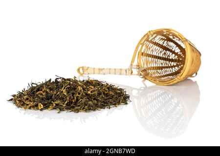 Dry black tea leaves with bamboo strainer isolated on white background Stock Photo