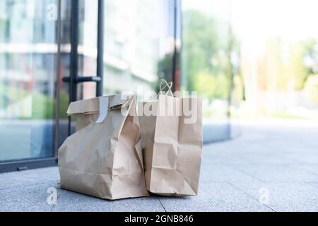 Paper bag near door of house. Safe delivery concept. Contactless home food delivery. Precautionary measures. Stock Photo