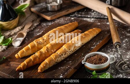 Homemade roll with seeds, garlic and basil Stock Photo